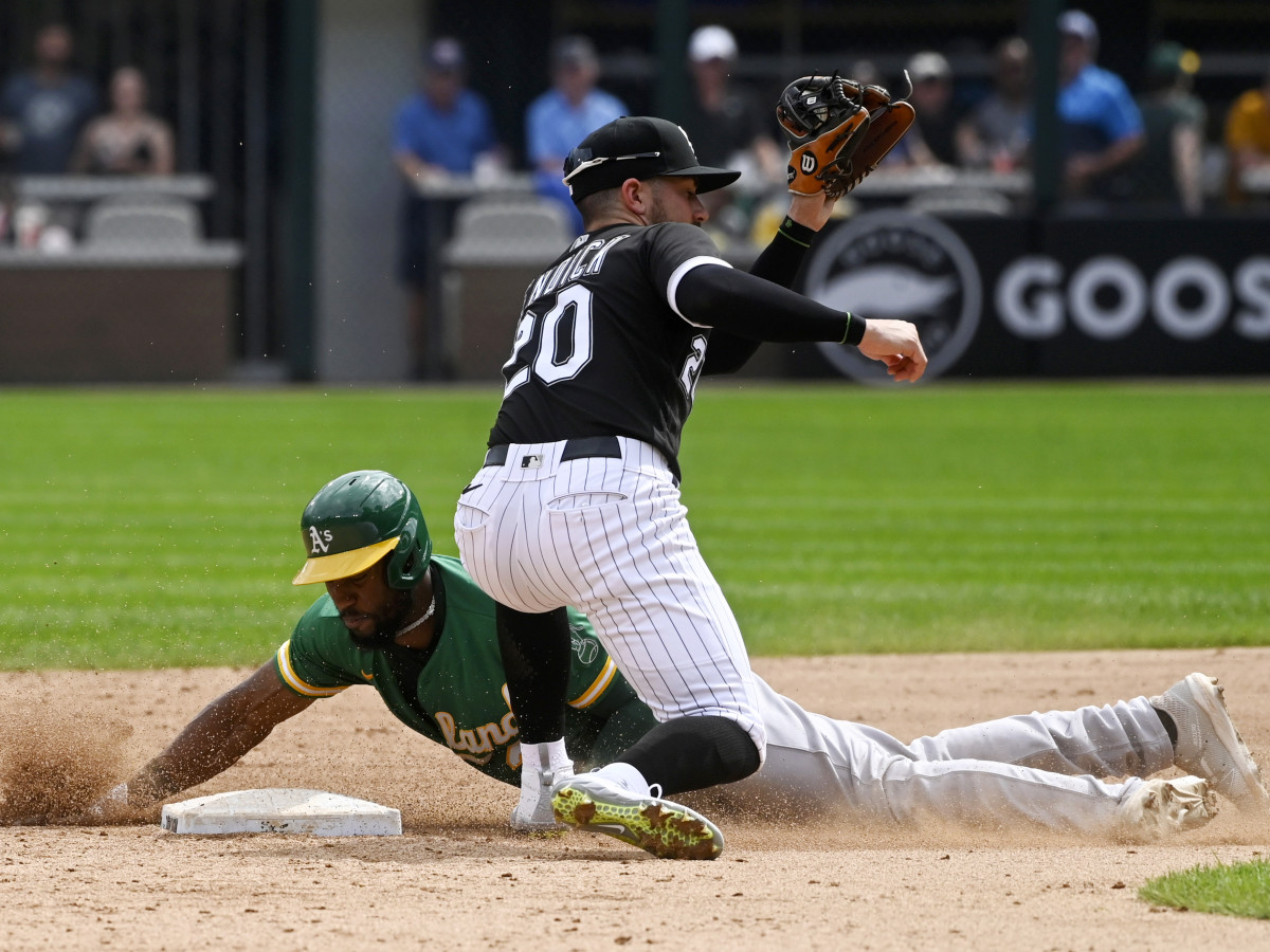 Aug 19, 2021; Chicago, Illinois, USA; Chicago White Sox second baseman Danny Mendick (20) misses the tag on Oakland Athletics center fielder Starling Marte (2) during the fifth inning at Guaranteed Rate Field.